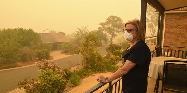 Photo of a woman wearing a mask in a high smoke level environment
